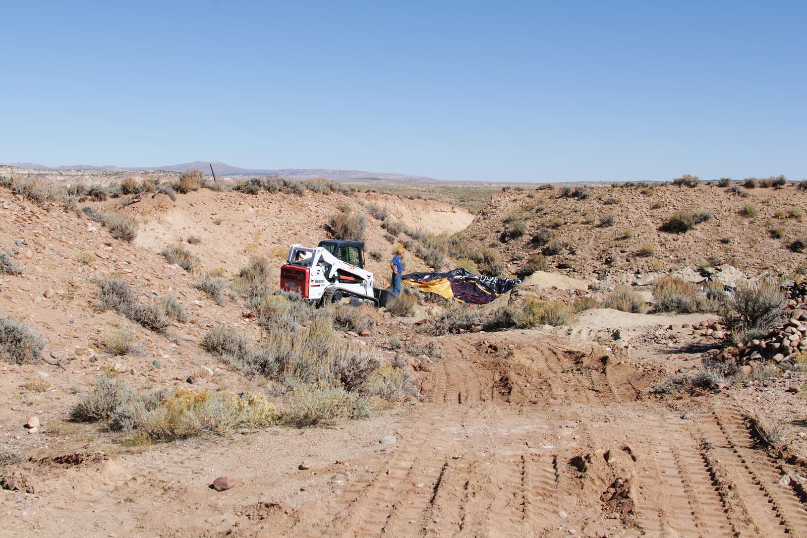 The terrace country in section — test pit exposing the shallow gravel blanket.